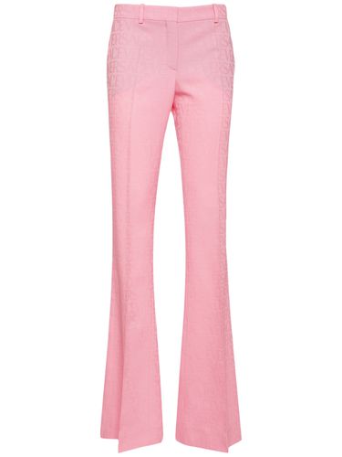 Logo Jacquard Wool Flared Pants - VERSACE - Modalova