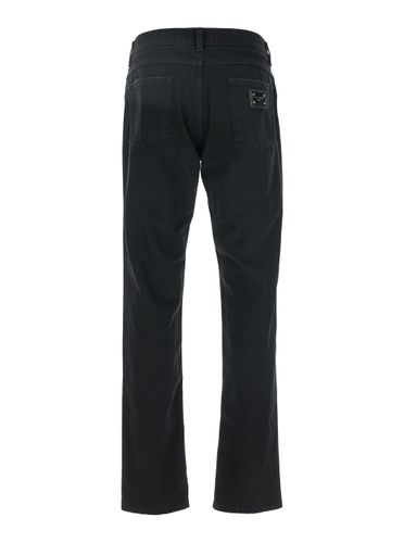 Black High Waist Jeans With Ripped Details And Logo Patch On The Rear In Denim Man - Dolce & Gabbana - Modalova