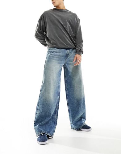 X013 - Jeans con fondo ampio a vita medio alta lavaggio medio - Collusion - Modalova