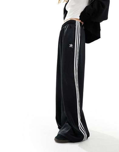 Joggers a fondo ampio neri in raso - adidas Originals - Modalova