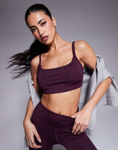 Active - Reggiseno sportivo a sostegno medio bordeaux con imbottitura rimovibile - ASOS - Modalova