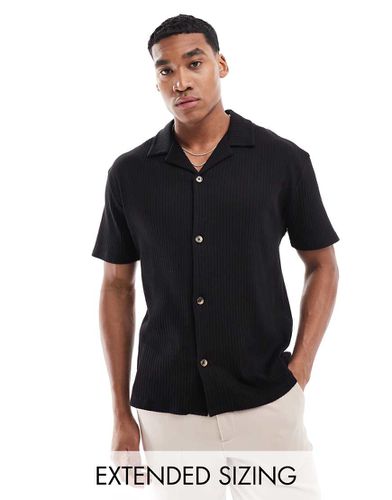 Camicia polo vestibilità comoda nera a coste - ASOS DESIGN - Modalova