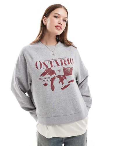 Felpa oversize mélange con grafica "Ontario" e maniche raglan - ASOS DESIGN - Modalova