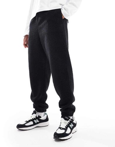 Joggers oversize neri in pile borg - ASOS DESIGN - Modalova