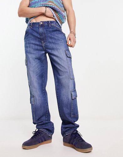 Jeans a fondo ampio lavaggio scuro con tasche cargo - ASOS DESIGN - Modalova