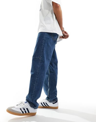 Jeans ampi lavaggio medio con baffature - ASOS DESIGN - Modalova