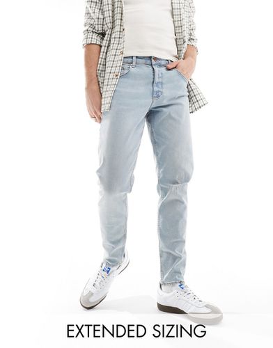 Jeans affusolati lavaggio chiaro con strappi - ASOS DESIGN - Modalova