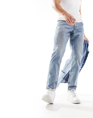 Jeans affusolati lavaggio medio tinto vintage con abrasioni - ASOS DESIGN - Modalova