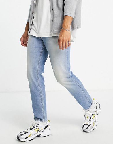 Jeans affusolati lavaggio chiaro con abrasioni - ASOS DESIGN - Modalova