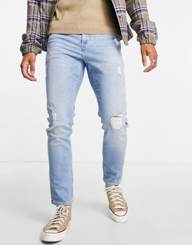 Jeans slim elasticizzati lavaggio chiaro vintage con abrasioni - ASOS DESIGN - Modalova