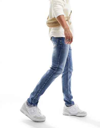 Jeans slim elasticizzati lavaggio tinto medio - ASOS DESIGN - Modalova