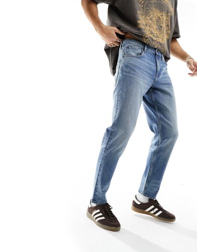 Jeans stretch affusolati lavaggio medio - ASOS DESIGN - Modalova