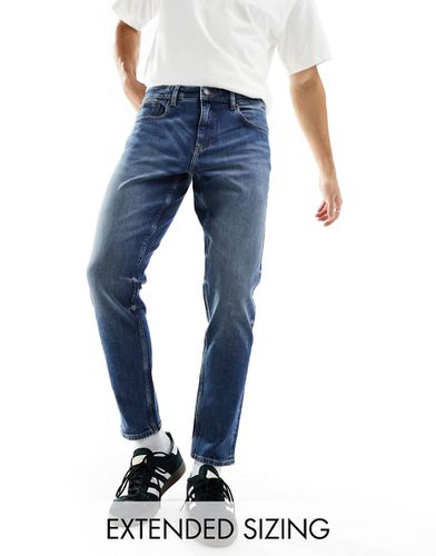 Jeans stretch affusolati lavaggio scuro - ASOS DESIGN - Modalova