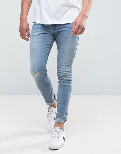 Jeans super skinny medio slavato con abrasioni - ASOS DESIGN - Modalova