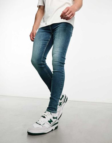 Jeans power stretch lavaggio scuro - ASOS DESIGN - Modalova