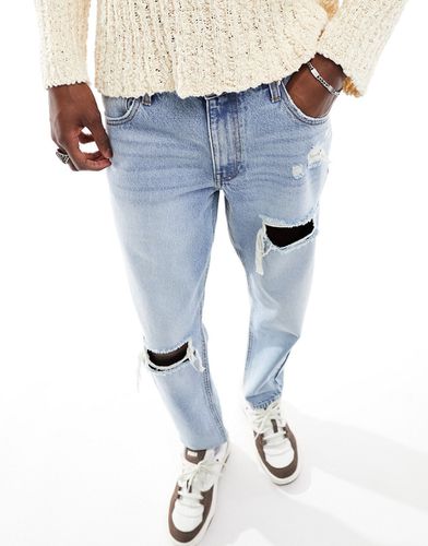 Jeans rigidi modello classico lavaggio chiaro con strappi - ASOS DESIGN - Modalova