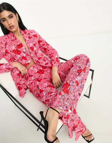 Pantaloni a zampa con stampa di papaveri - ASOS DESIGN - Modalova