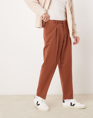 Pantaloni affusolati eleganti oversize color ruggine con pieghe sul davanti - ASOS DESIGN - Modalova