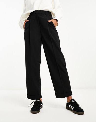 Pantaloni affusolati neri palma con risvolto sul fondo - ASOS DESIGN - Modalova