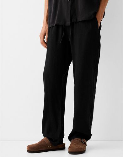 Pantaloni con fondo ampio in lino neri - Bershka - Modalova