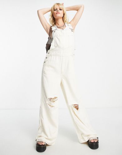 Salopette di jeans extra larga bianca con strappi - Free People - Modalova