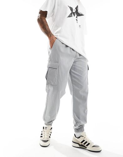 Pantaloni cargo chiaro con fondo elasticizzato - New Look - Modalova