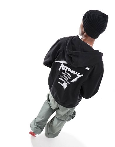 Felpa nera regular con cappuccio e logo stile vernice spray - Tommy Jeans - Modalova