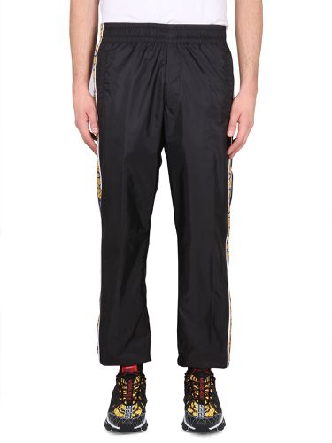 Jogging pants with baroque print - versace - Modalova