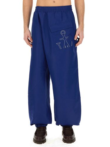 Joggers pants with logo anchor - jw anderson - Modalova