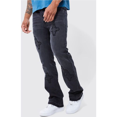 Jeans a zampa Slim Fit in denim rigido con applique a croce - boohoo - Modalova