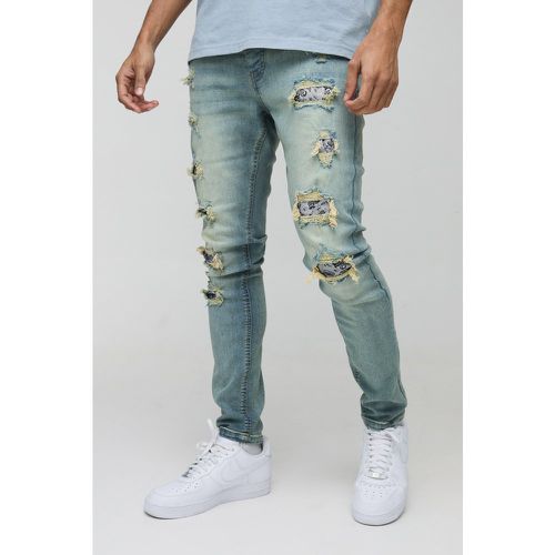 Jeans Skinny Fit slavati con strappi & rattoppi - boohoo - Modalova