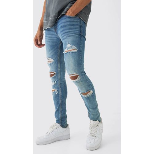 Jeans Skinny Fit con strappi all over - boohoo - Modalova