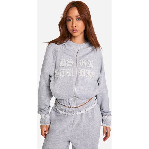 Felpa Dsgn Studio con applique in tessuto effetto smagliato, zip e cappuccio - boohoo - Modalova