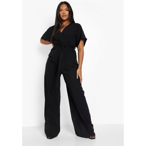 Tuta intera Plus Size a gamba ampia con cintura - boohoo - Modalova