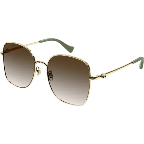 Gold/Braun getönte Sonnenbrille,Goldene Sonnenbrille mit Zubehör - Gucci - Modalova