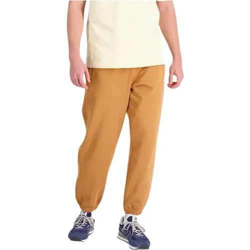 Sweatpants, male, , Size: M Solid color jumpsuit with ribbed cuffs - New Balance - Modalova