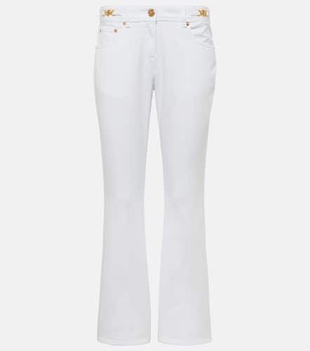 Embellished low-rise flared jeans - Versace - Modalova