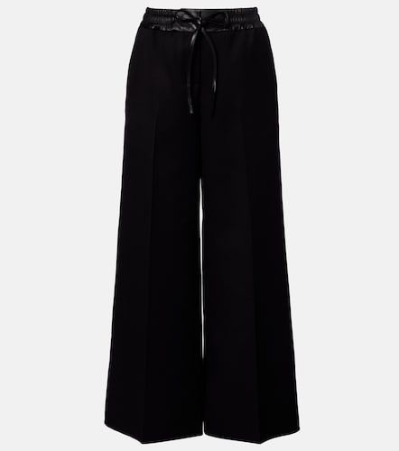 Leather-trimmed virgin wool wide-leg pants - Alaia - Modalova