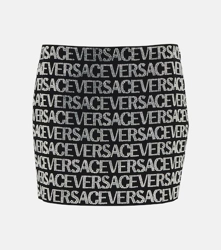 Minigonna con logo e decorazioni - Versace - Modalova