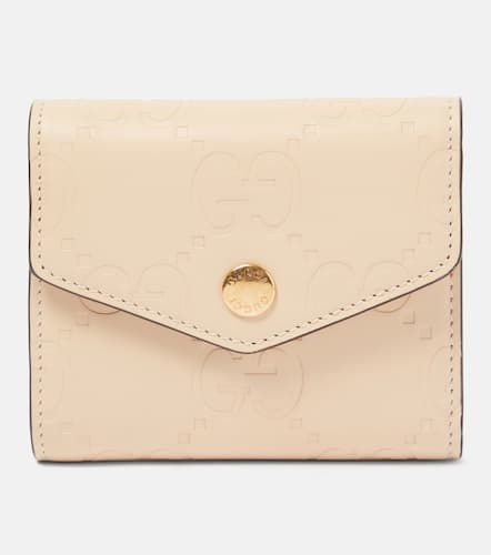Medium GG debossed leather wallet - Gucci - Modalova