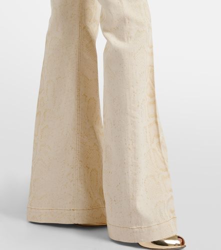 Jeans flared con stampa serpente - Roberto Cavalli - Modalova